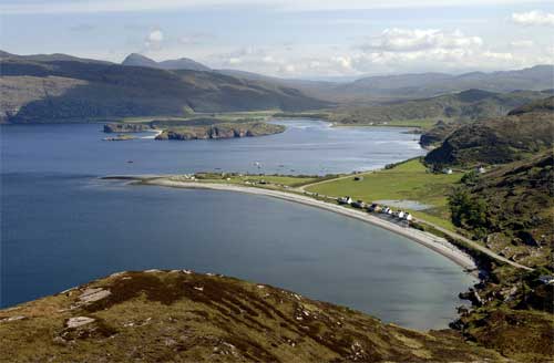 The long narrow triangle of land is a spit built by longshore drift.  The grass covered part of the spit formed when sea level was higher. NW Highlands, UK.