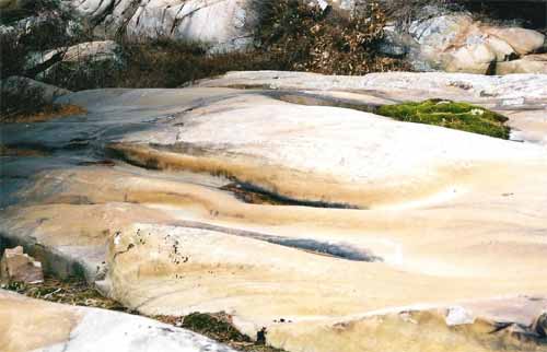 Curving channels (called P-forms) carved into bedrock, Killarney Provincial Park, Ontario, Canada. © Abigail Burt